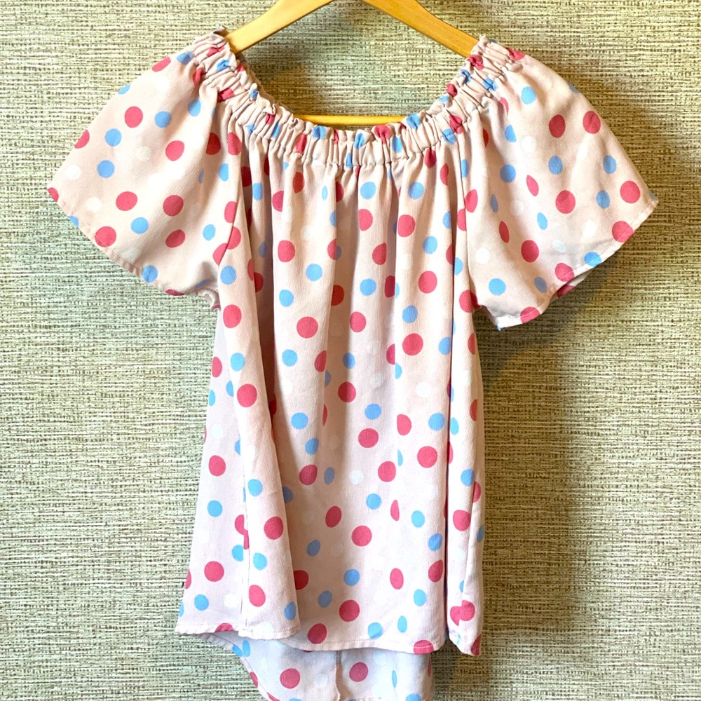 Pink, white, and sky blue polkadot blouse.